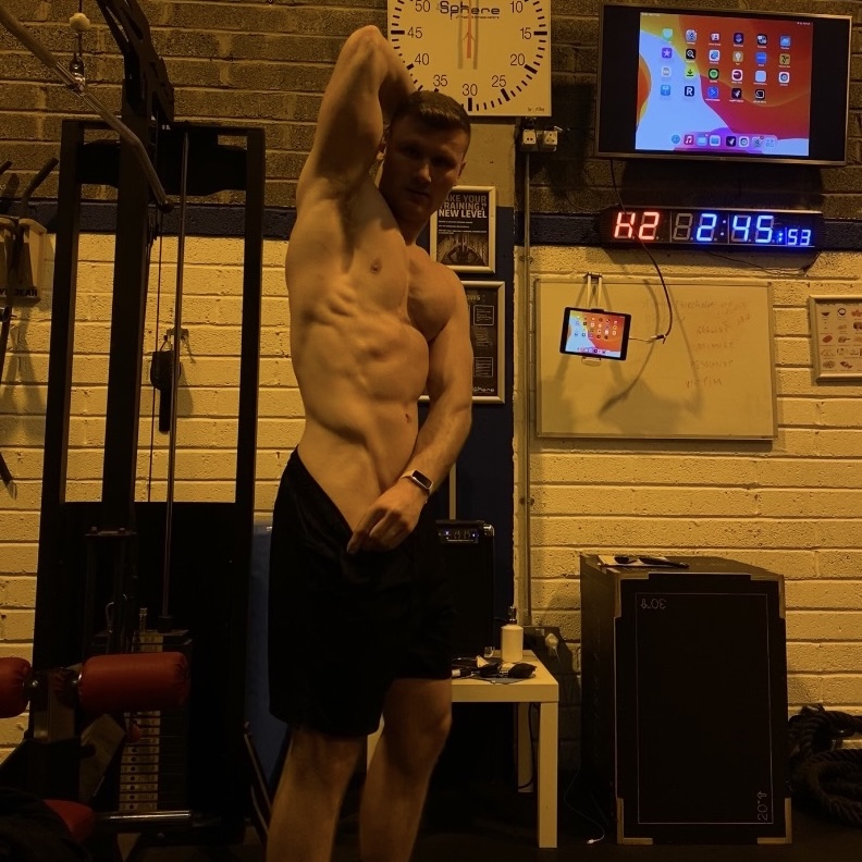 Daniel posing in the gym